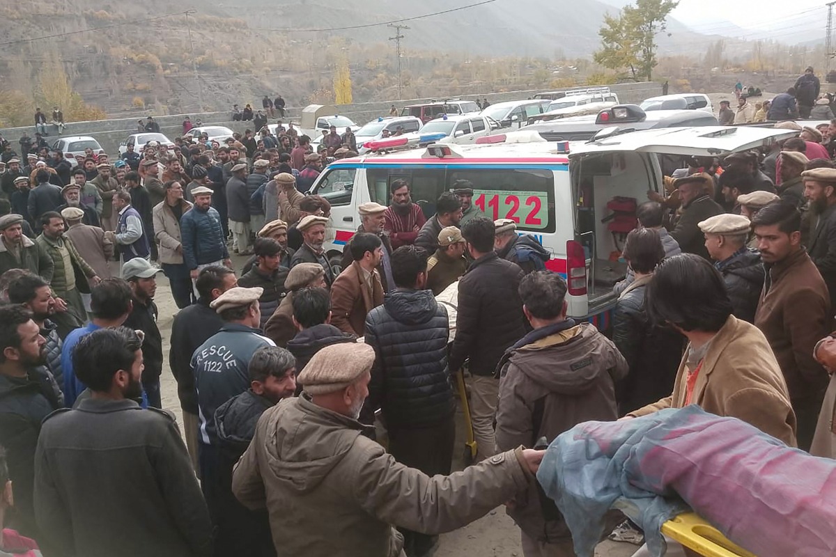 In this photograph taken and released by Pakistan's Gilgit-Baltistan Emergency Service (Rescue 1122) on November 13, 2024, mourners carry a deceased's body who died in a wedding bus accident in Gilgit. Photo by Gilgit Baltistan Emergency Service (Rescue 1122) / AFP