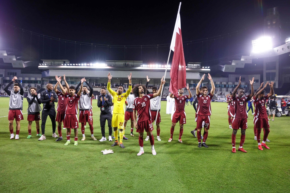 Qatar's players celebrate after winning the 2026 FIFA World Cup Asian qualification football match between Qatar and Uzbekistan at the Jassim bin Hamad Stadium in Doha on November 14, 2024. (Photo by Karim Jaafar / AFP)