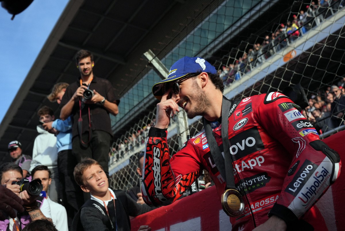 Ducati Italian rider Francesco Bagnaia smiles as he celebrates gettinhg the pole position after winning the Moto GP sprint race of the Solidarity Grand Prix of Barcelona at the Circuit de Catalunya on November 16, 2024 in Montmelo on the outskirts of Barcelona. Photo by Manaure Quintero / AFP.