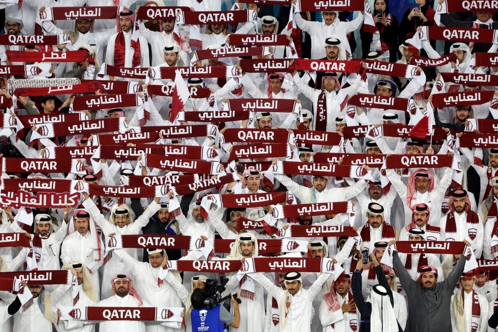 Qatar's fans cheer during the Qatar 2023 AFC Asian Cup semi-final match between Iran and Qatar at al-Thumama Stadium on February 7, 2024. Photo by KARIM JAAFAR / AFP

