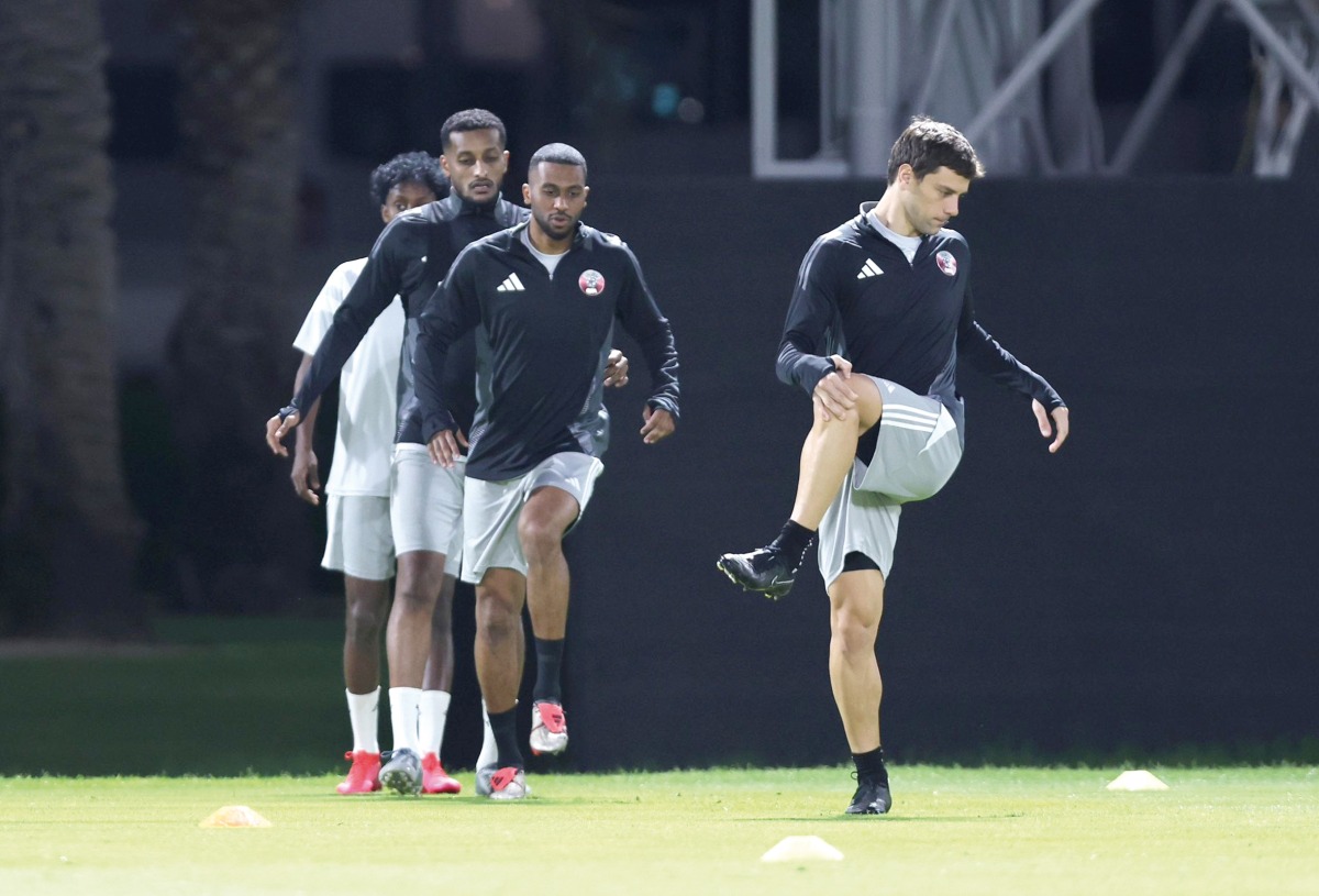 Lucas Mendes (right) and teammates attend Qatar's training session held in Doha just hours before team's departure to Abu Dhabi yesterday. 