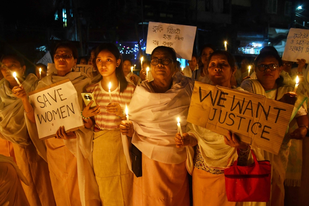 Women holding placards and candles take part in a demonstration in Guwahati on November 18, 2024, to condemn the alleged killing of women and children by militants in the Jiribam district of India's violence-hit northeastern state of Manipur. (Photo by Biju Boro / AFP)
 