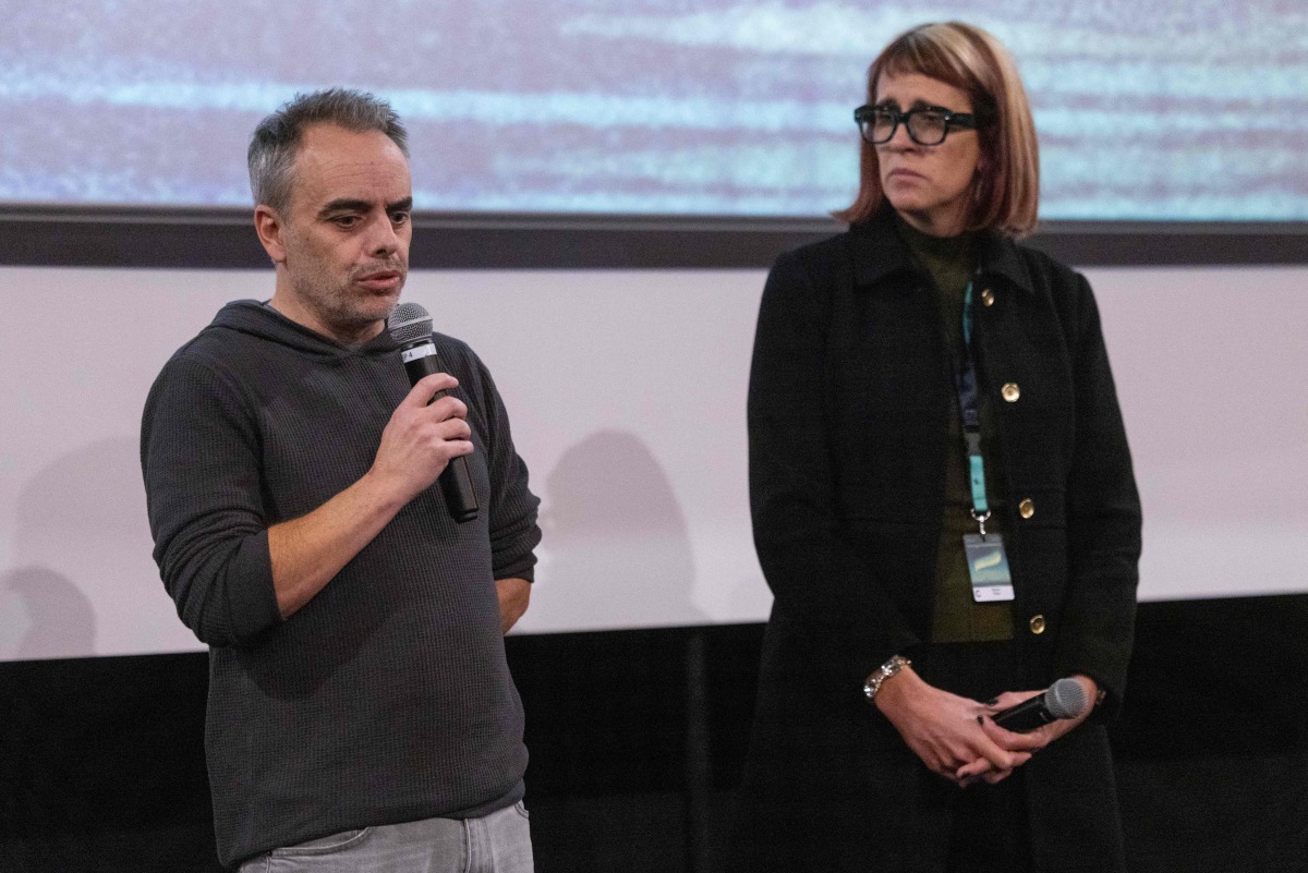 US film director Joel Souza (L) and cinematographer Bianca Cline (R) stand on stage before the first screening of the 