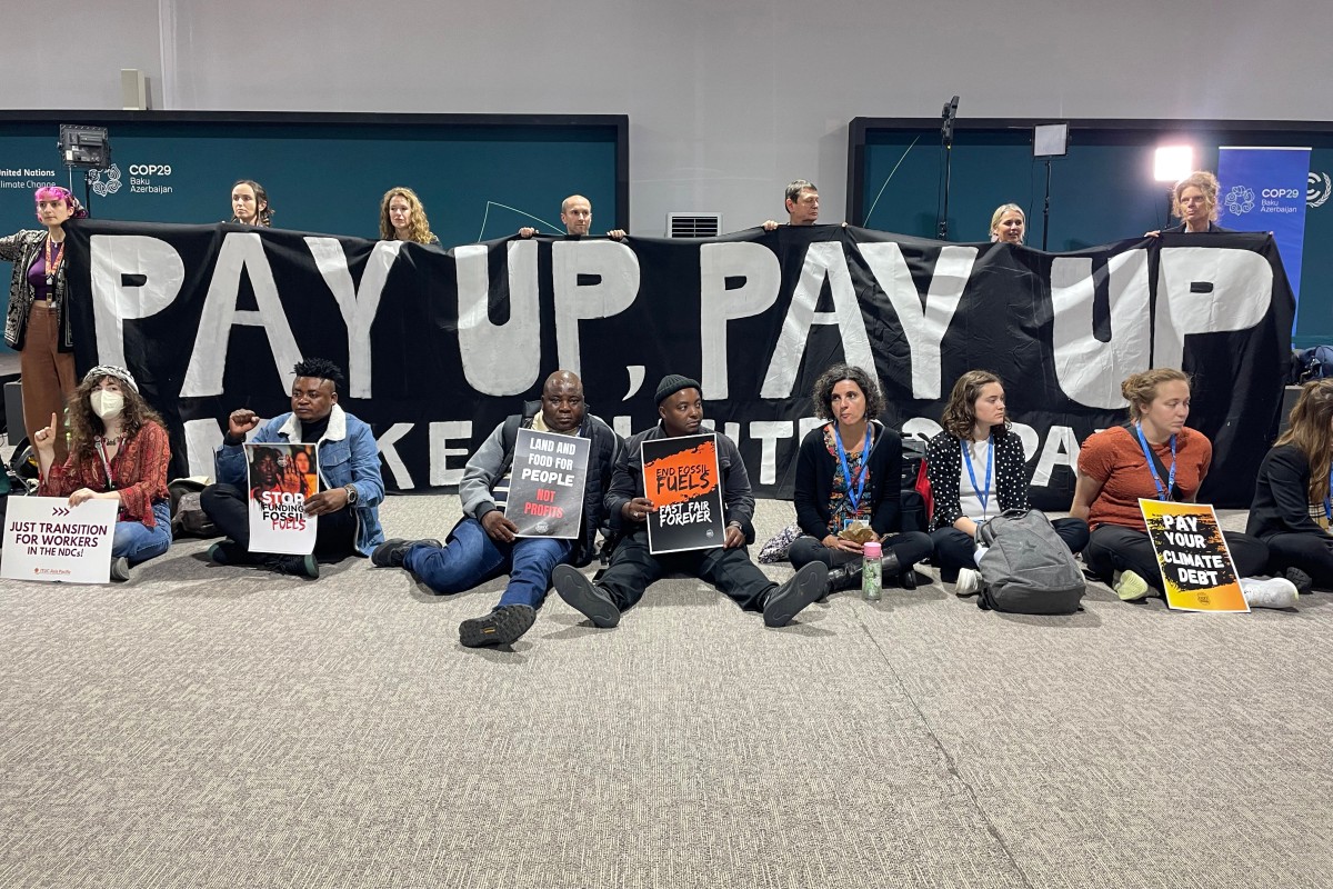 Activists hold a silent protest inside the COP29 venue to demand that rich nations provide climate finance to developing countries, during the United Nations Climate Change Conference (COP29) in Baku on November 16, 2024. Photo by Laurent THOMET / AFP.