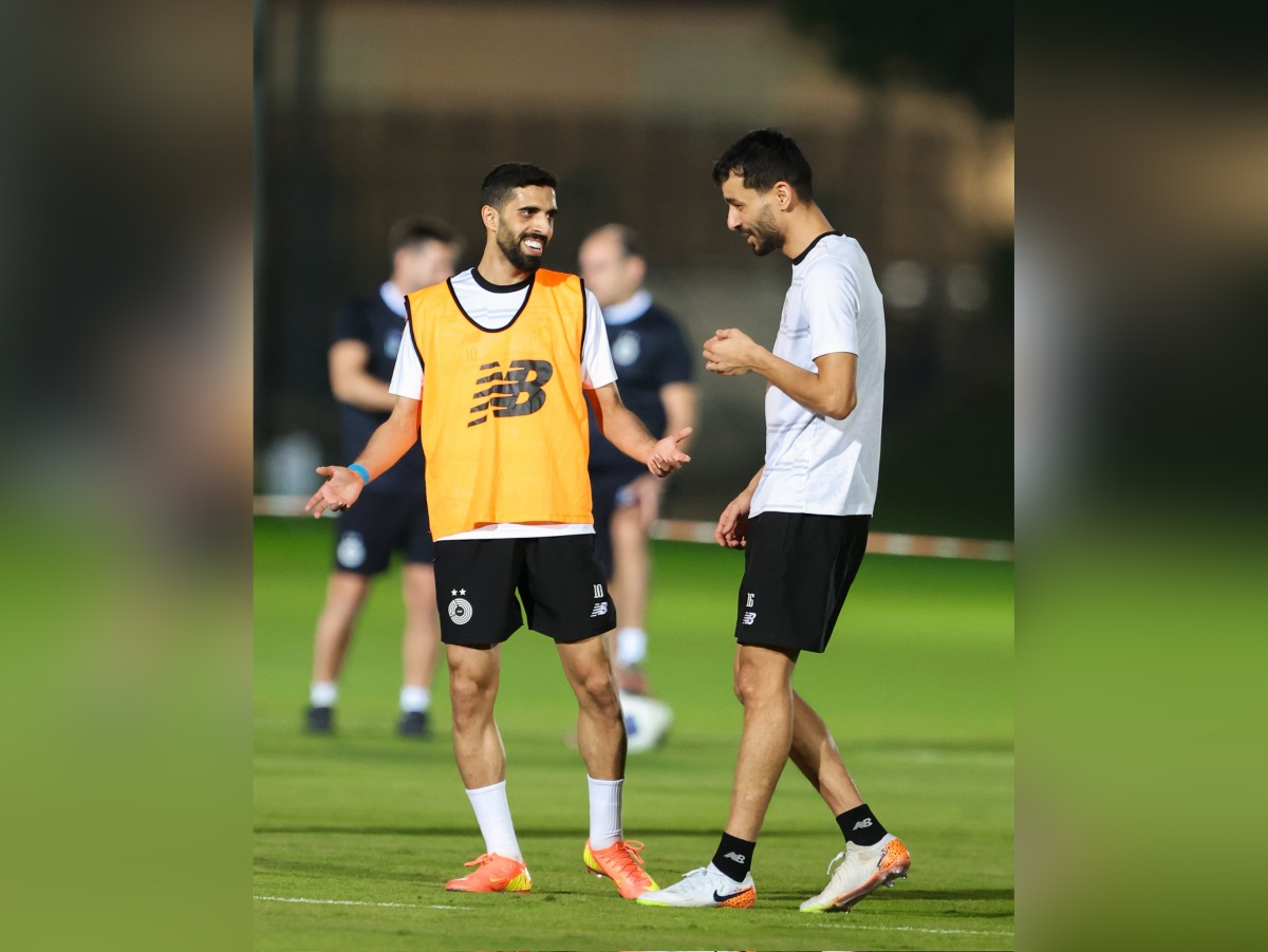 Al Sadd's Hassan Al Haydos (left) with Boualem Khoukhi during a training session.