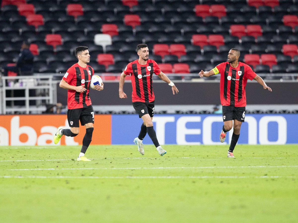 Al Rayyan’s Achraf Bencharki (left) celebrates with teammates after scoring the equaliser. 