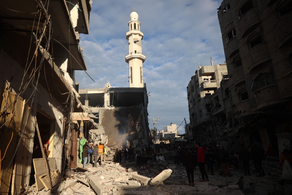 Palestinians inspect the damage at the site of an Israeli airstrike in the Nuseirat camp in central Gaza on November 27, 2024. (Photo by Eyad Baba / AFP)