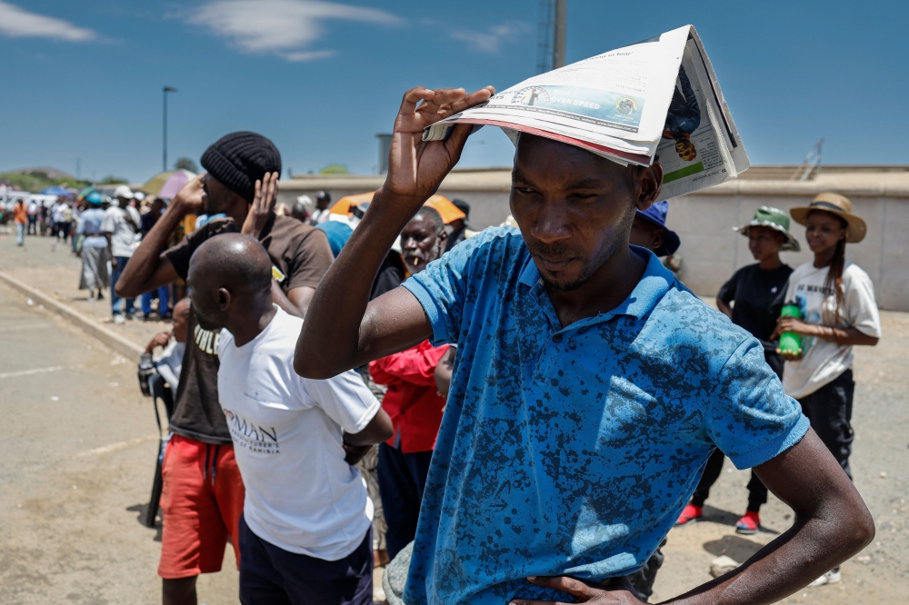 Voters queue at a polling station at the Sam Nujoma stadium in Windhoek on November 27, 2024 during Namibia's general election. (Photo by Simon Maina / AFP)