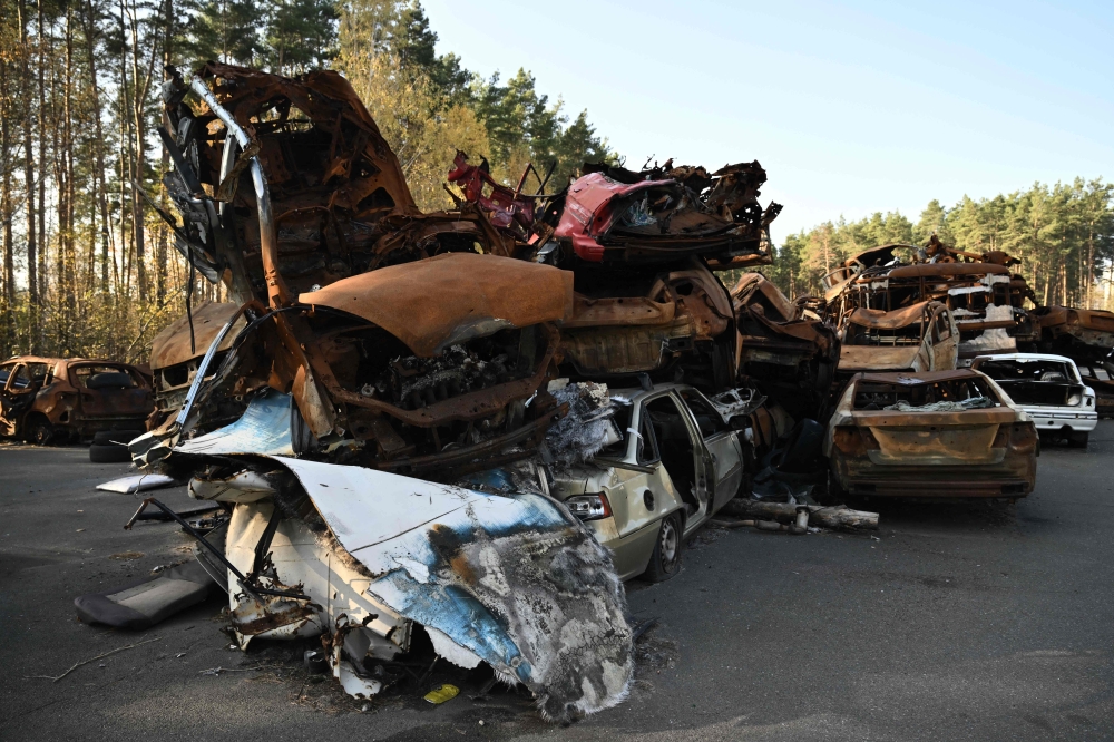 This photograph taken in Irpin, near Kyiv, on November 7, 2024, shows the symbolic cemetery of destroyed civilian cars. (Photo by Genya Savilov / AFP)