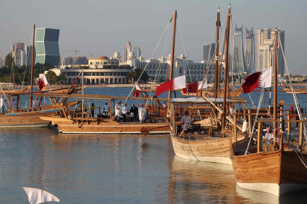 Traditional wooden boats sail during the 14th Traditional Dhow Festival at the Katara Cultural Village Foundation in Doha on November 27, 2024. (Photo by Karim Jaafar / AFP)