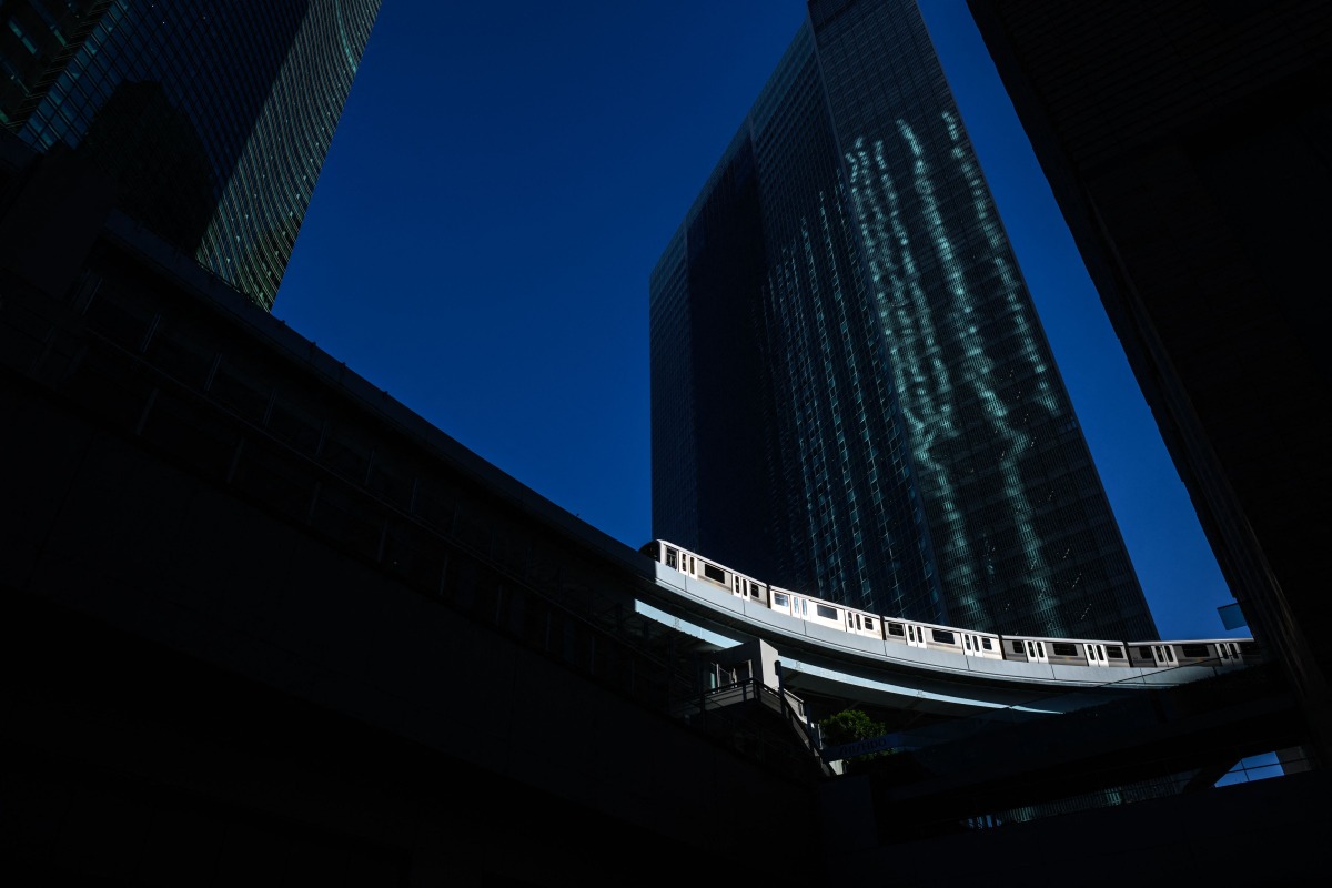 A train of Yurikamome railway line, the city's first fully automated train system, travels past the Shiodome business area in Tokyo on November 29, 2024. Photo by Philip FONG / AFP