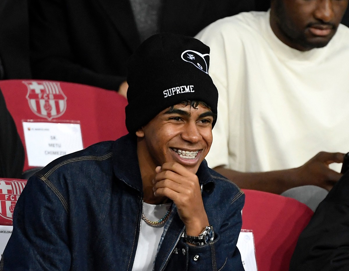 Barcelona's Spanish forward #19 Lamine Yamal injured is pictured in the stands prior the UEFA Champions League, league phase day 5 football match between FC Barcelona and Stade Brestois 29 (Brest) at the Estadi Olimpic Lluis Companys in Barcelona, on November 26, 2024. Photo by Josep LAGO / AFP.