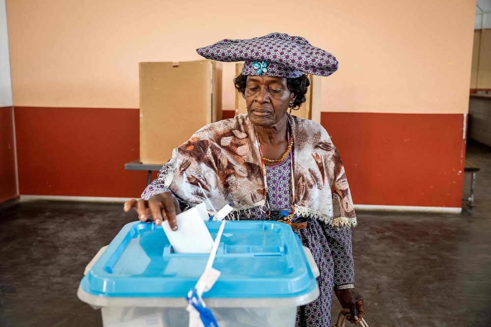 A woman casts her vote at a polling station in Windhoek on November 29, 2024, during extended voting following the country's general election. (Photo by Simon Maina / AFP)