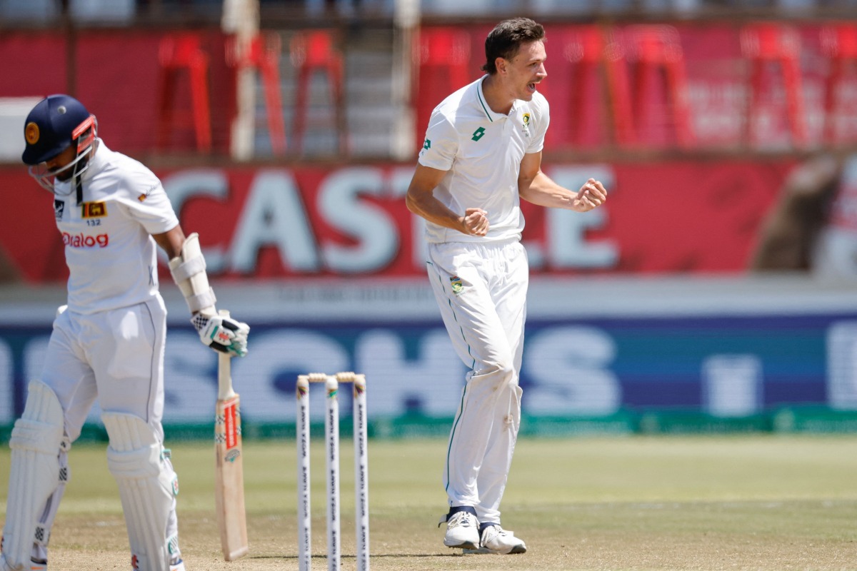 South Africa's Marco Jansen (R) celebrates after dismissing Sri Lanka's Vishwa Fernando (L) during the fourth day of the first Test cricket match between South Africa and Sri Lanka at the Kingsmead stadium in Durban on November 30, 2024. (Photo by Phill Magakoe / AFP)
