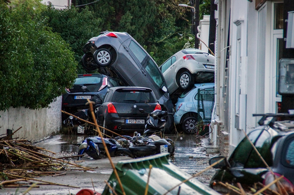 Cars piled on top of each other in the city of Rhodes after heavy rainfall, on the Greek island of Rhodes, on December 1, 2024. (Photo by Stringer / Eurokinissi / AFP) 
 