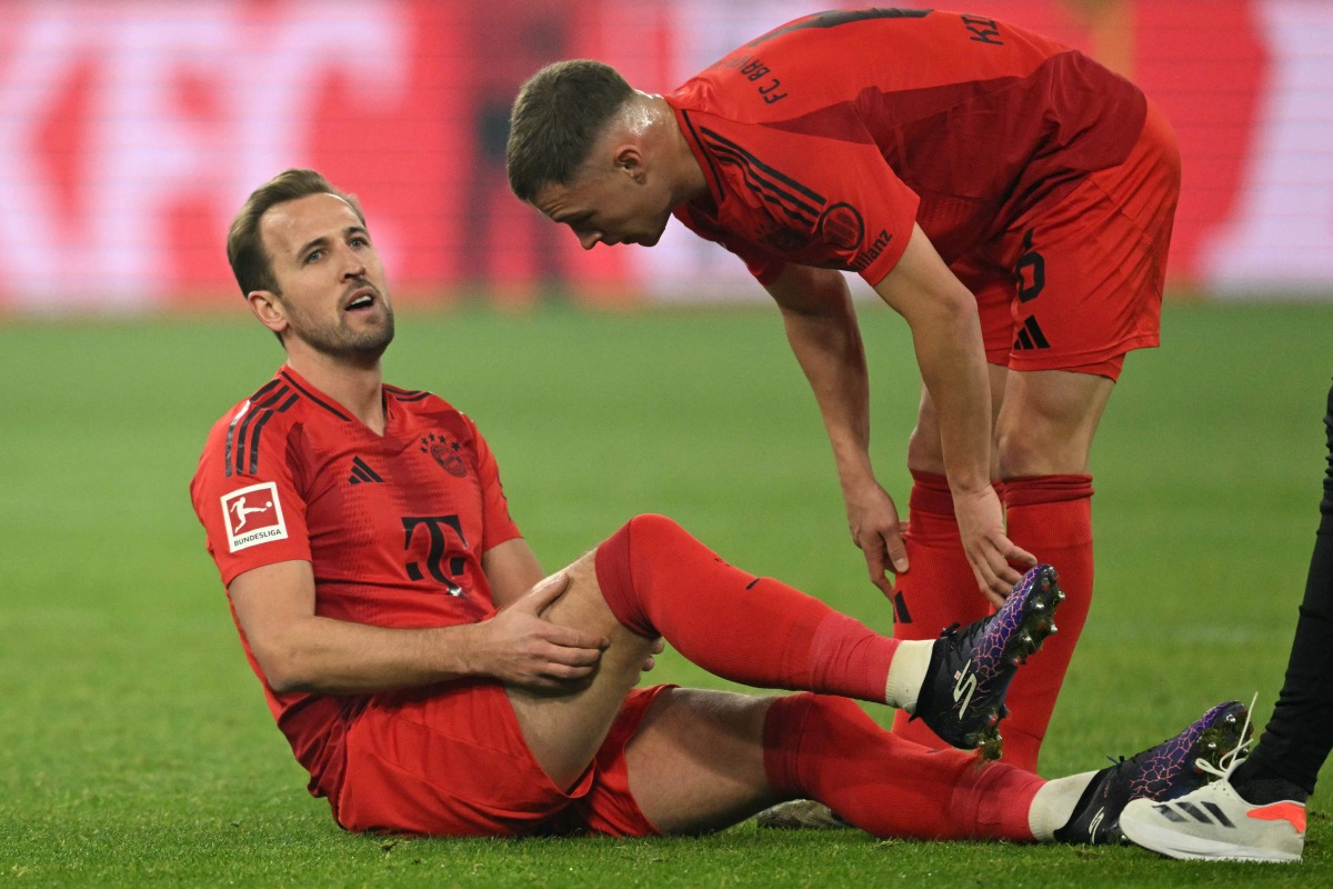 Bayern Munich's English forward #09 Harry Kane (L) speaks with Bayern Munich's German midfielder #06 Joshua Kimmich after an injury during the German first division Bundesliga football match between BVB Borussia Dortmund and FC Bayern Munich in Dortmund, western Germany on November 30, 2024. (Photo by INA FASSBENDER / AFP) 