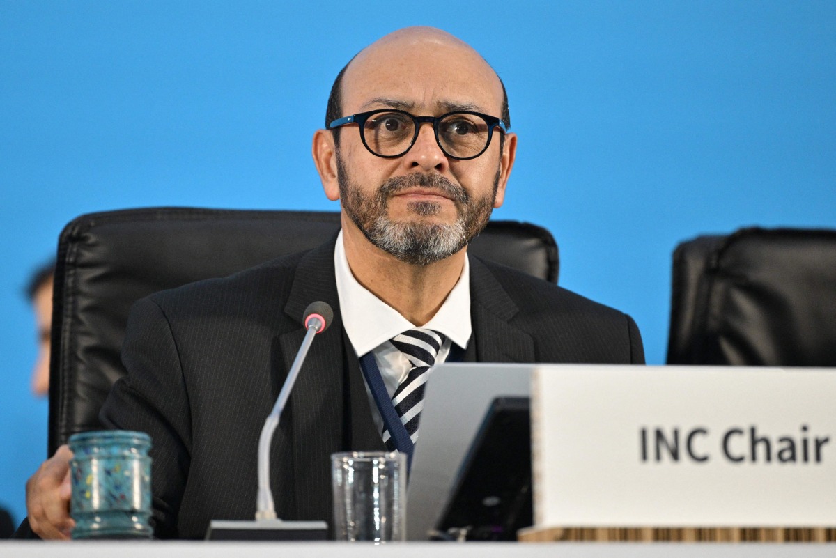 INC-5 Chair Luis Vayas Valdivieso brings down a gavel, made using recycled plastic bottle tops from the Dandora landfill in Nairobi, during the start of a plenary of the fifth session of the UN Intergovernmental Negotiating Committee on Plastic Pollution (INC-5) in Busan on December 1, 2024. (Photo by Anthony WALLACE / AFP)