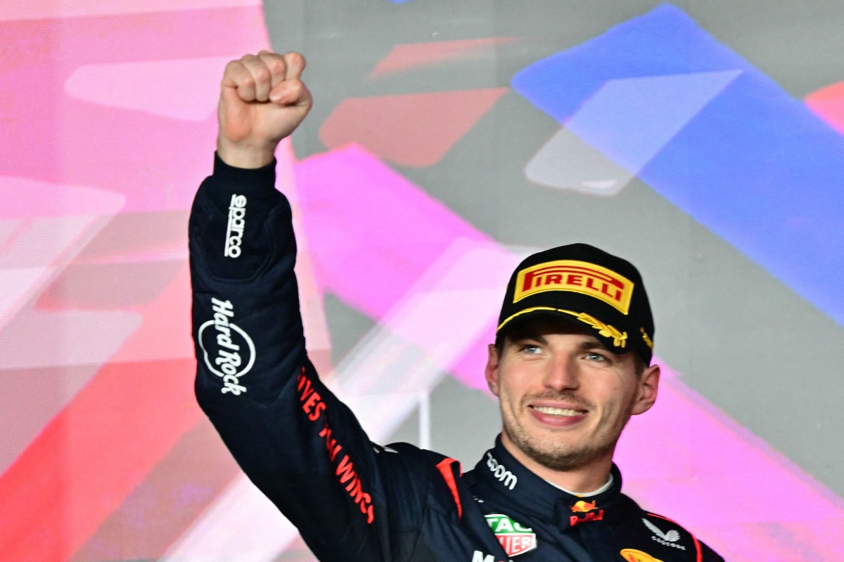 Race winner Red Bull Racing's Dutch driver Max Verstappen celebrates on the podium after the Qatari Formula One Grand Prix at the Lusail International Circuit in Lusail, north of Doha, on December 1, 2024. (Photo by Giuseppe CACACE / AFP)
