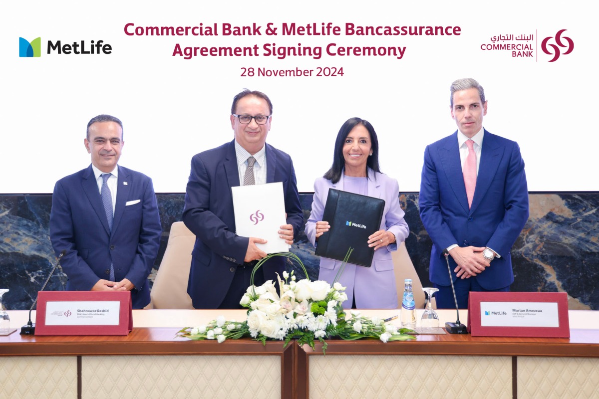 Commercial Bank, MetLife officials during the agreement signing ceremony.