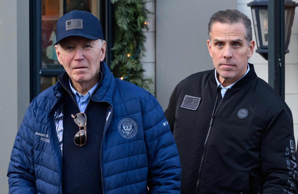 A November 29, 2024 photo shows US President Joe Biden and son Hunter Biden stepping out of a bookstore while shopping in Nantucket, Massachusetts on November 29, 2024. (Photo by Mandel Ngan / AFP)