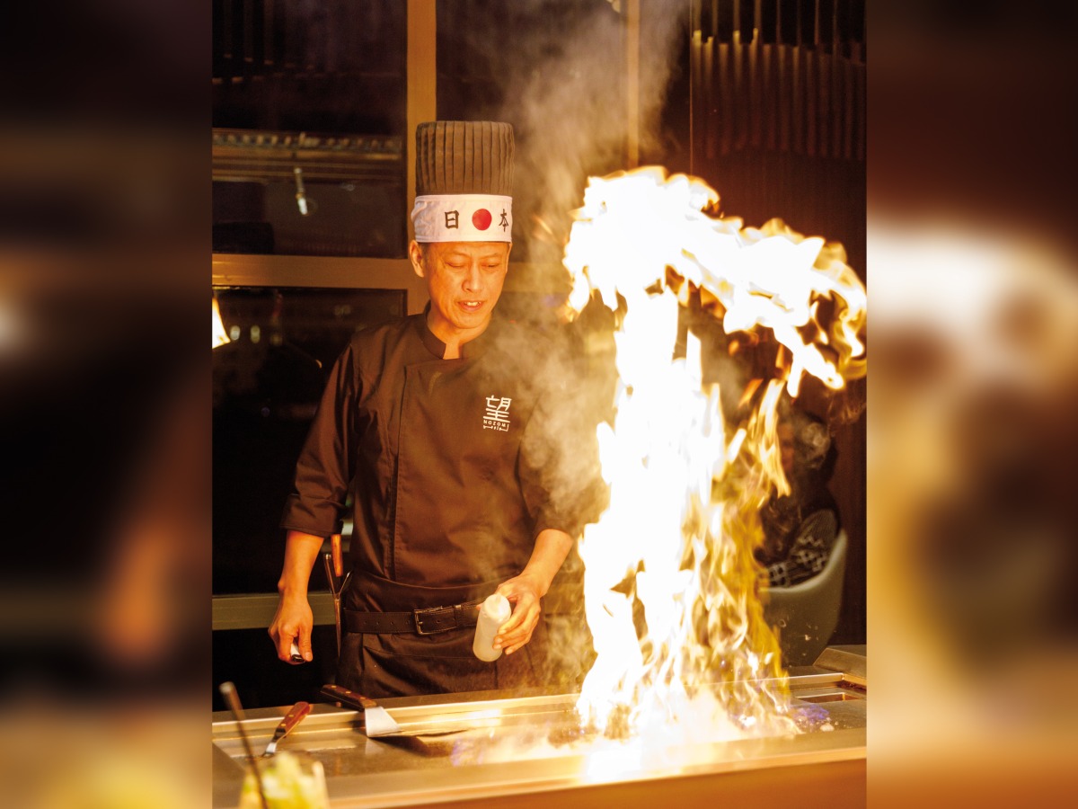 A chef at work at Nozomi Doha.