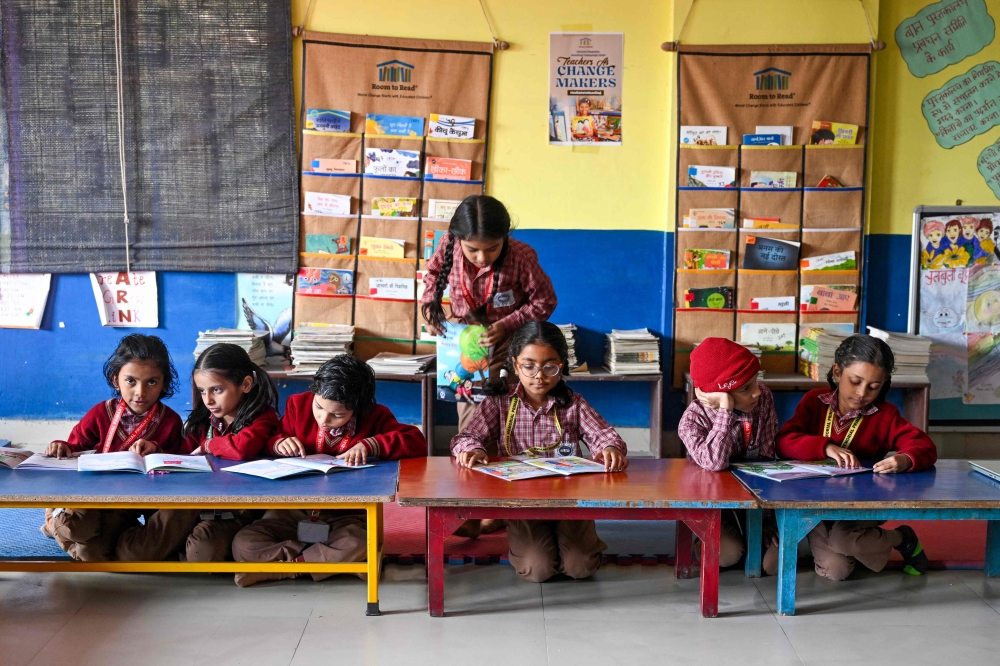 Children attend a class at a school in New Delhi on December 3, 2024. (Photo by Arun Sankar / AFP)