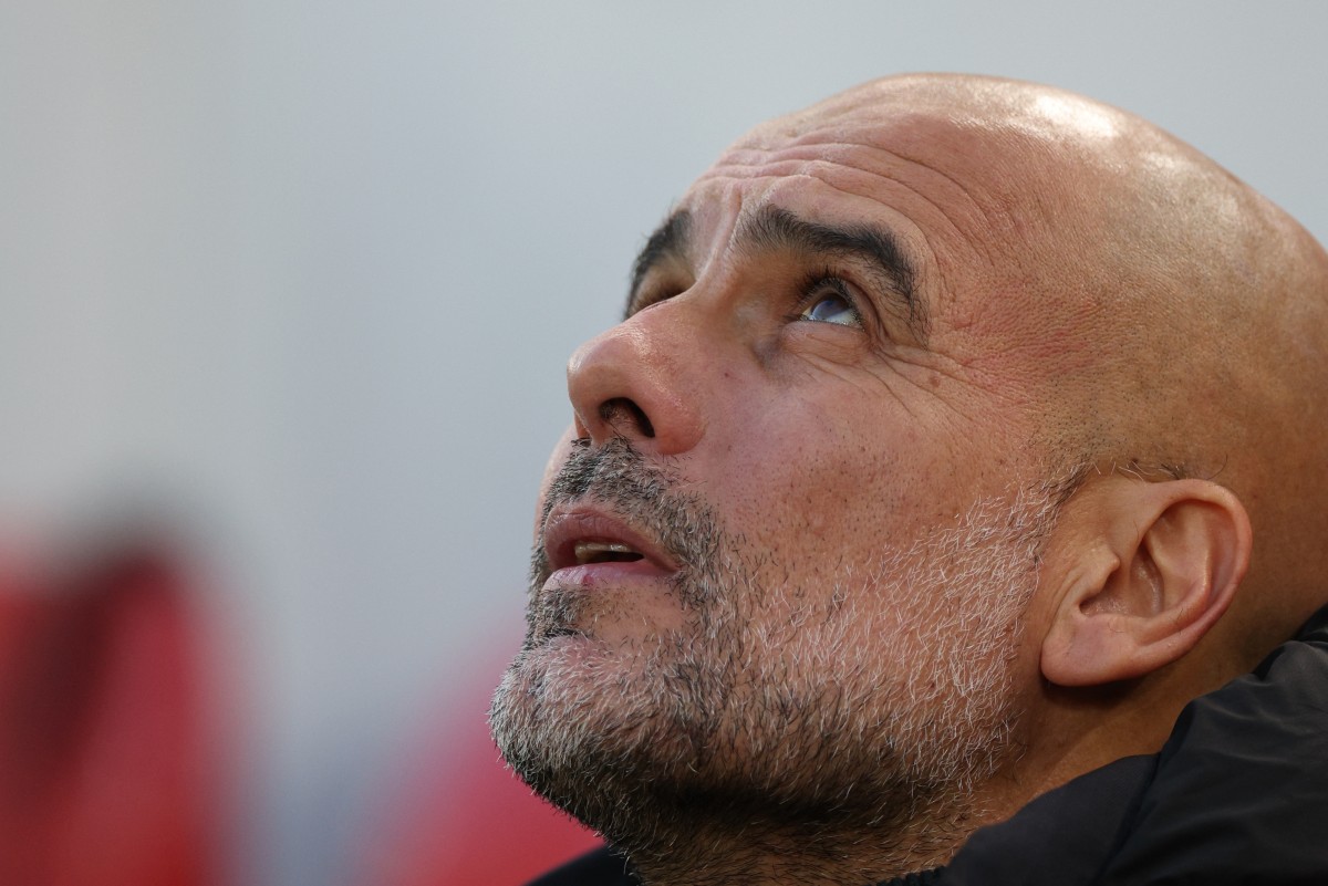 Manchester City's Spanish manager Pep Guardiola looks on from his seat ahead of kick-off in the English Premier League football match between Liverpool and Manchester City at Anfield in Liverpool, north west England on December 1, 2024. Photo by Adrian Dennis / AFP.