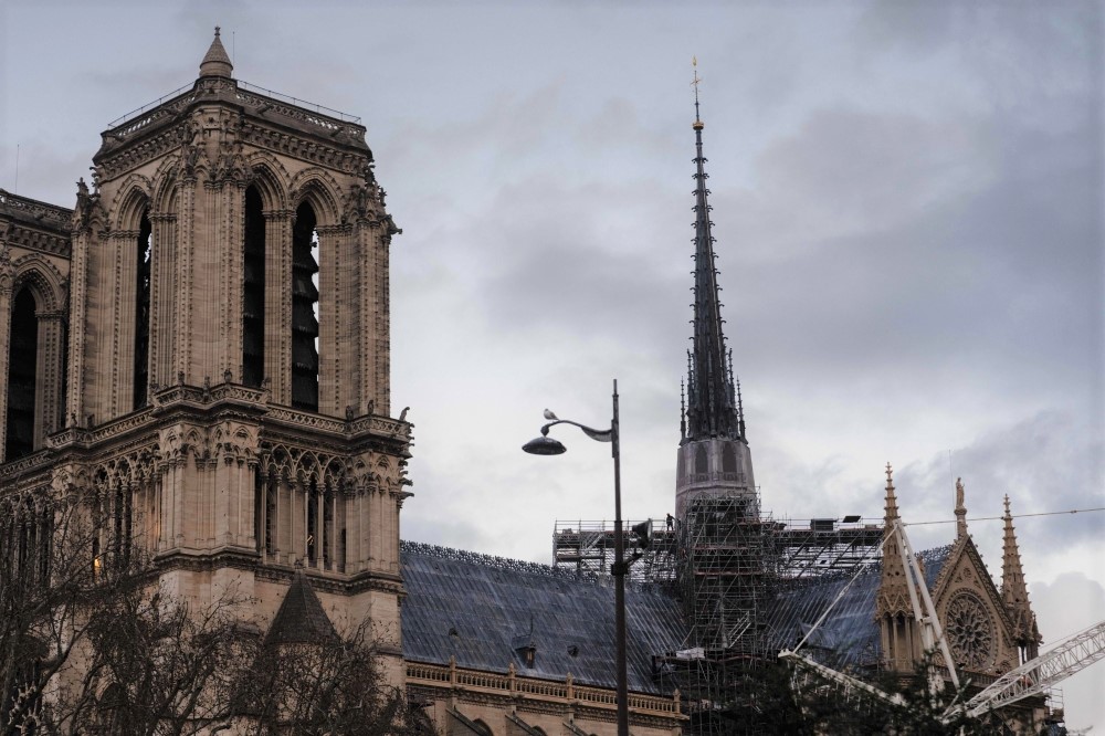 A construction worker walks on scaffoldings on the roof of Notre-Dame de Paris cathedral, a few days before its reopening in Paris, on December 2, 2024. (Photo by Dimitar Dilkoff / AFP)