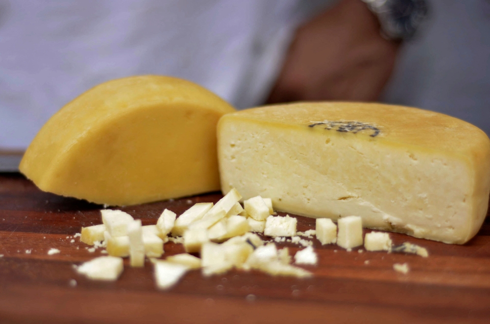 Handout picture released by Minas Gerais Culture Department (Secult-MG) shows a handmade Minas Cheese during an exhibition at the city of Belo Horizonte, Minas Gerais state, Brazil on October 19, 2024. (Photo by Renata Garbocci / Minas Gerais Culture Department (Secult-MG) / AFP) 