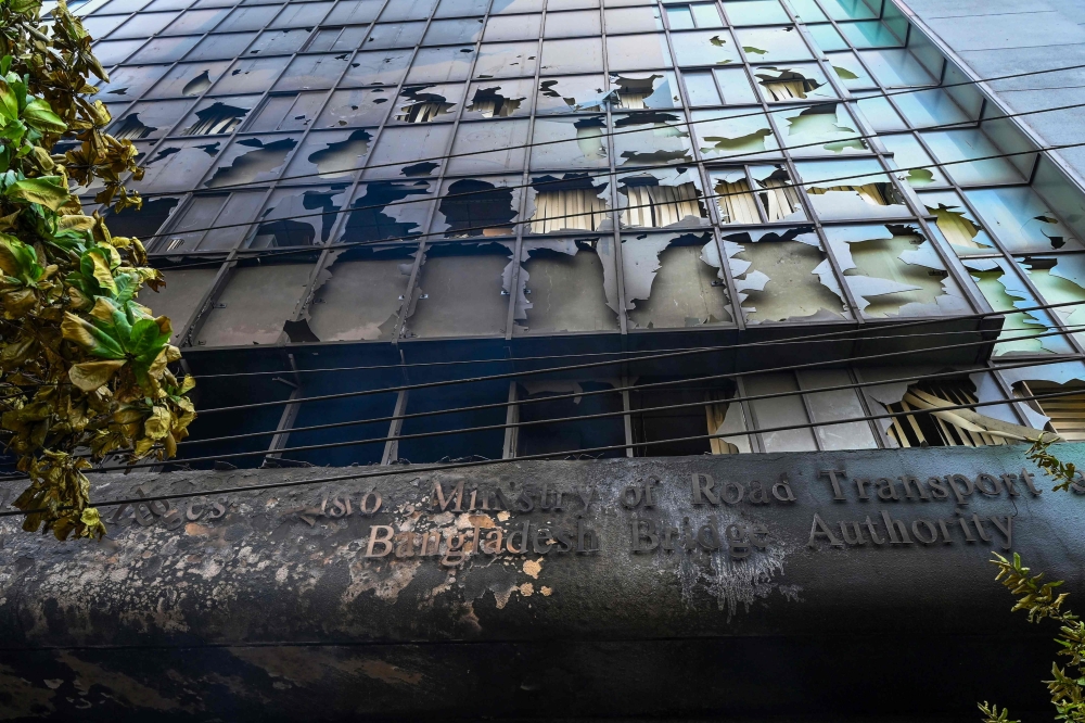 File: Burnt building of Bangladesh bridge authority is pictured after students set it on fire amid the ongoing anti-quota protest in Dhaka on July 19, 2024.  (Photo by Munir Uz Zaman / AFP)