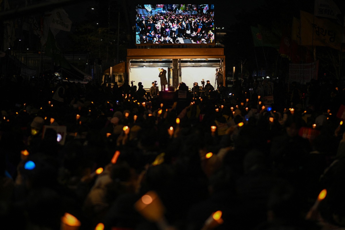 People take part in a protest calling for the ouster of South Korea President Yoon Suk Yeol outside the National Assembly in Seoul on December 6, 2024. Photo by Philip FONG / AFP