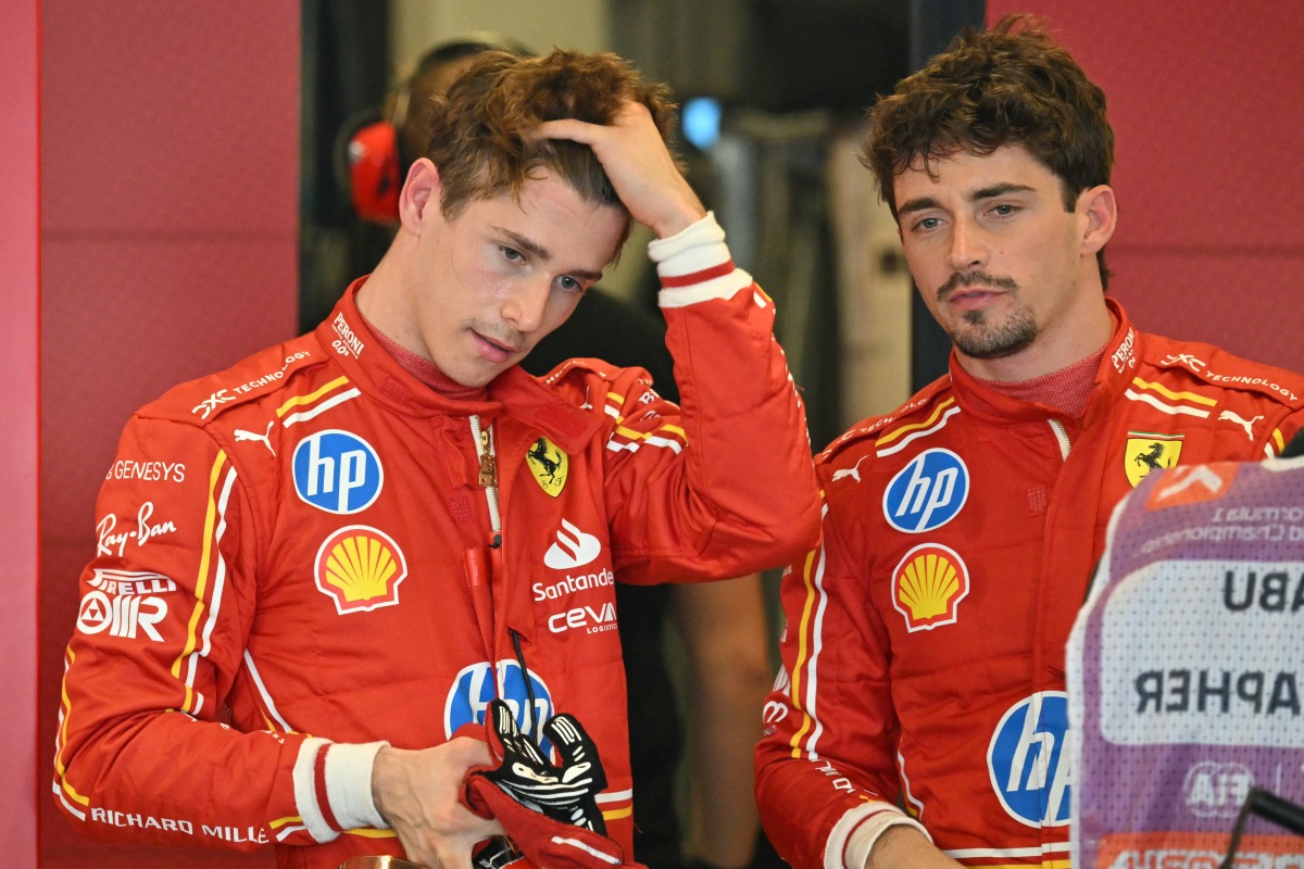 Ferrari's Monegasque driver Charles Leclerc (R) speaks to his brother Ferrari's reserve driver Arthur Leclerc after the first practice session ahead of the Abu Dhabi Formula One Grand Prix at the Yas Marina Circuit in Abud Dhabi on December 6, 2024. Photo by Andrej ISAKOVIC / AFP.