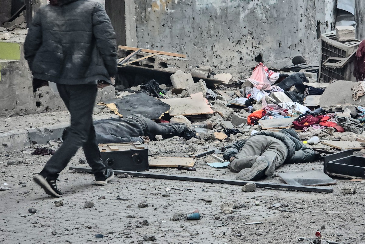 The bodies of victims lie amid the rubble in the courtyard of the Kamal Adwan hospital in Beit Lahya in the northern Gaza Strip, following a reported Israeli strike that hit the medical complex on December 6, 2024. Photo by AFP.