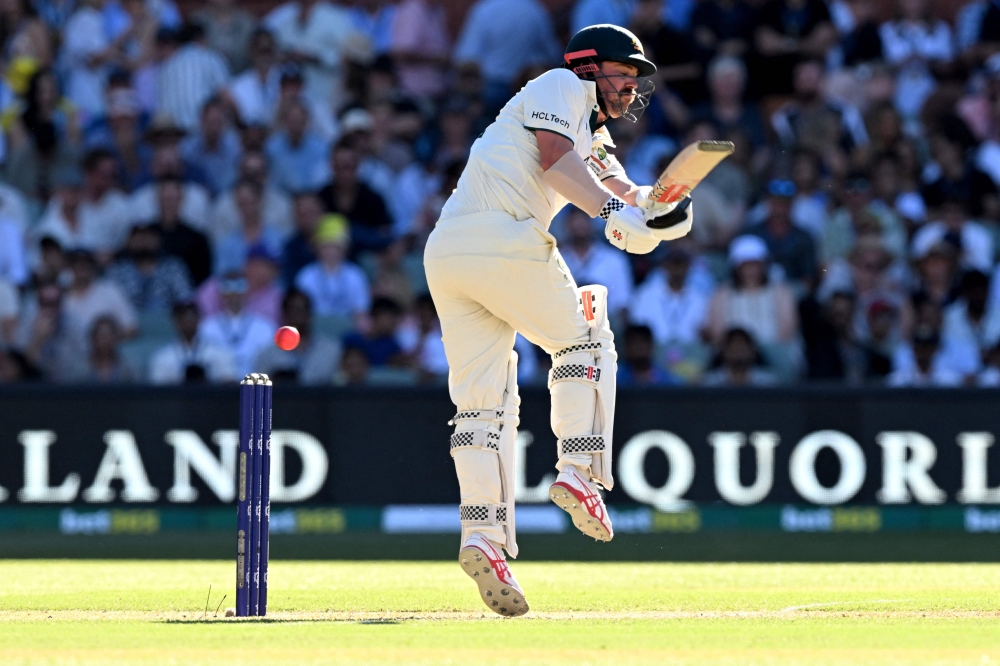 Australian batsman Travis Head plays a shot on the second day of the second Test cricket match between Australia and India at the Adelaide Oval in Adelaide on December 7, 2024. (Photo by William West / AFP) 
 