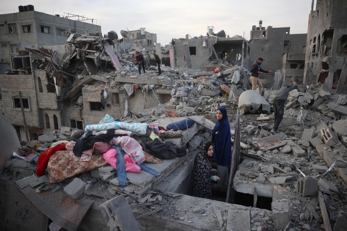 Palestinians inspect the damage after an Israeli strike on the Nuseirat refugee Camp in the central Gaza Strip on December 7, 2024. (Photo by Eyad BABA / AFP)
