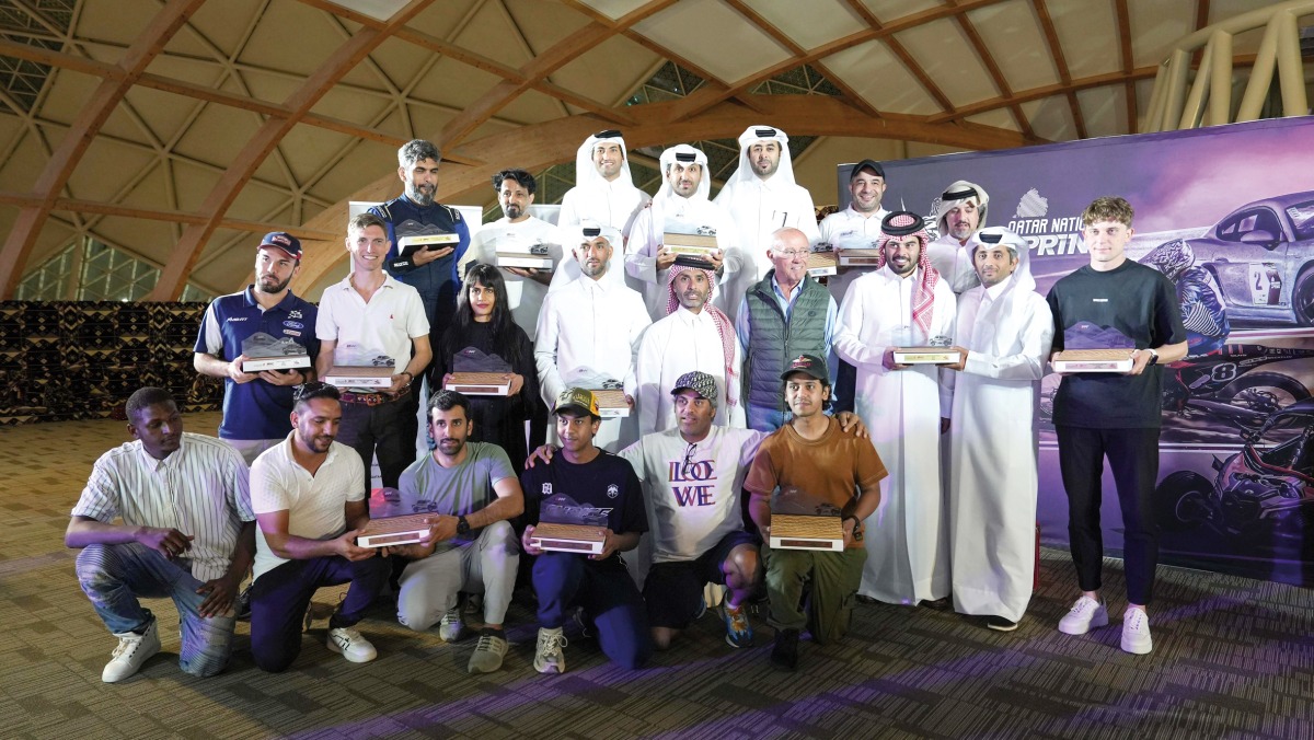 The winners of the 2024 Qatar Off Road Championship cars categories pose for a photo with officials.