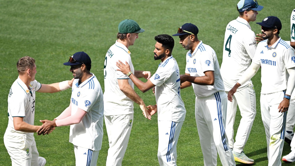 Indian and Australian players shake hands after the second Test match in Adelaide.