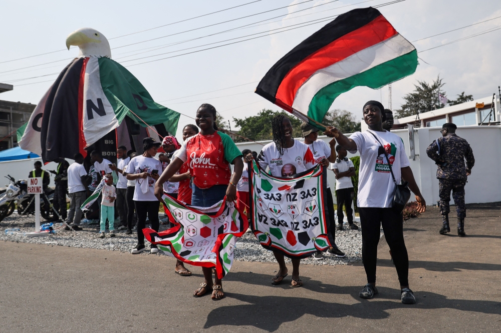 Supporters of Ghana's President and presidential candidate of the National Democratic Congress (NDC) party, John Mahama, celebrate after the opposition candidate, Ghana's Vice President and ruling New Patriotic Party (NPP) presidential candidate Mahamudu Bawumia, conceded defeat of the 2024 presidential election, in Accra on December 8, 2024. (Photo by Nipah Dennis / AFP)