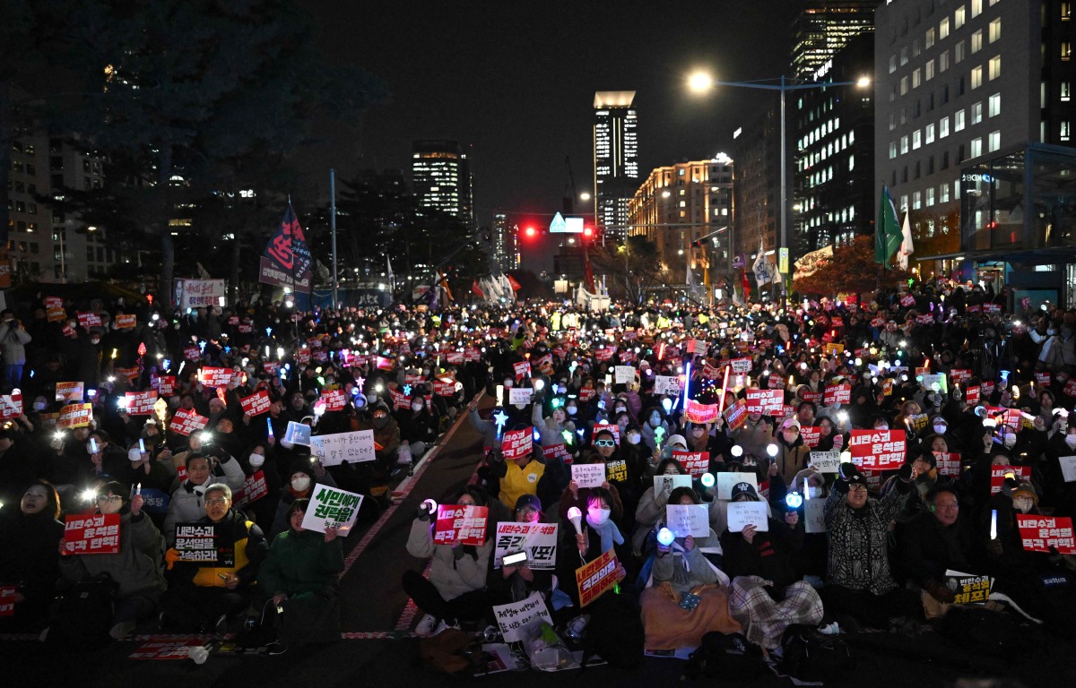 Protesters take part in a demonstration demanding President Yoon Suk Yeol's resignation outside the National Assembly in Seoul on December 10, 2024. Photo by Jung Yeon-je / AFP