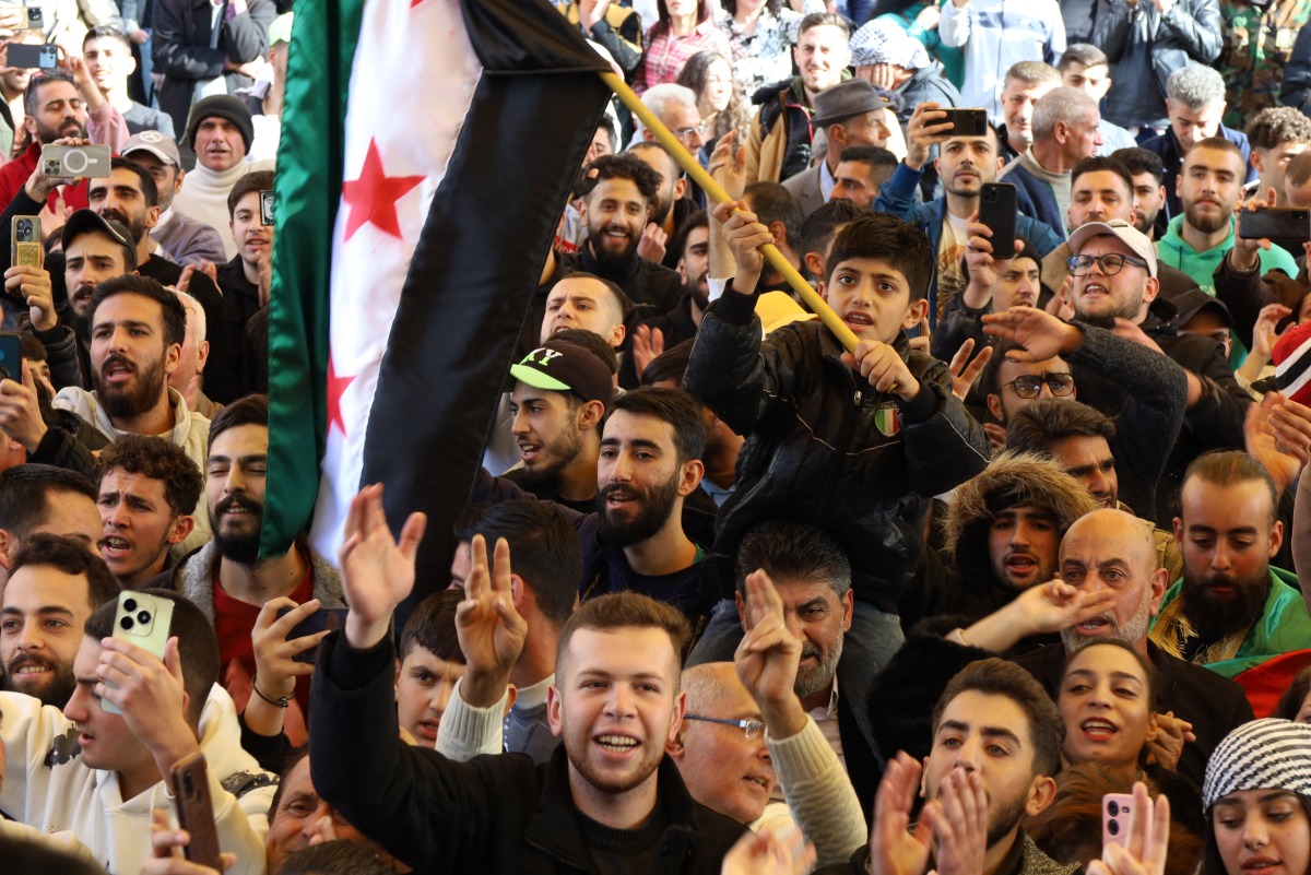 People cheer as they gather a the Karama square to welcome the arrival of rebel fighters from Aleppo and Daraa governorates in the southern Syrian city of Sweida on December 10, 2024.
Photo by SHADI AL DUBAISI / AFP.