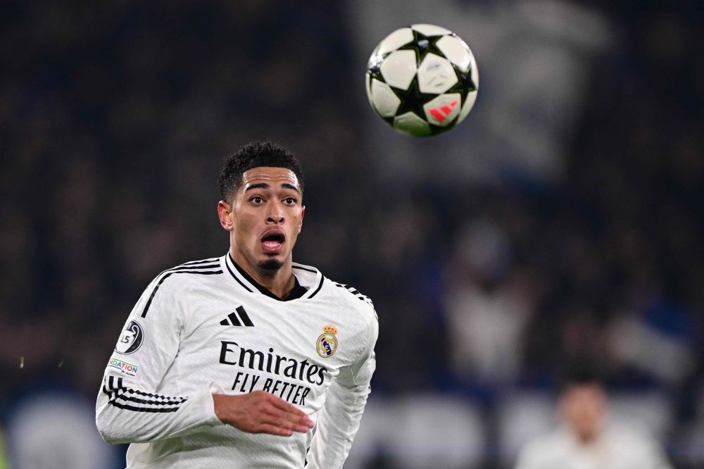 Real Madrid's English midfielder #05 Jude Bellingham runs for the ball during the UEFA Champions League football match between Atalanta and Real Madrid at the Gewiss Stadium in Bergamo, on December 10, 2024. (Photo by Marco Bertorello / AFP)