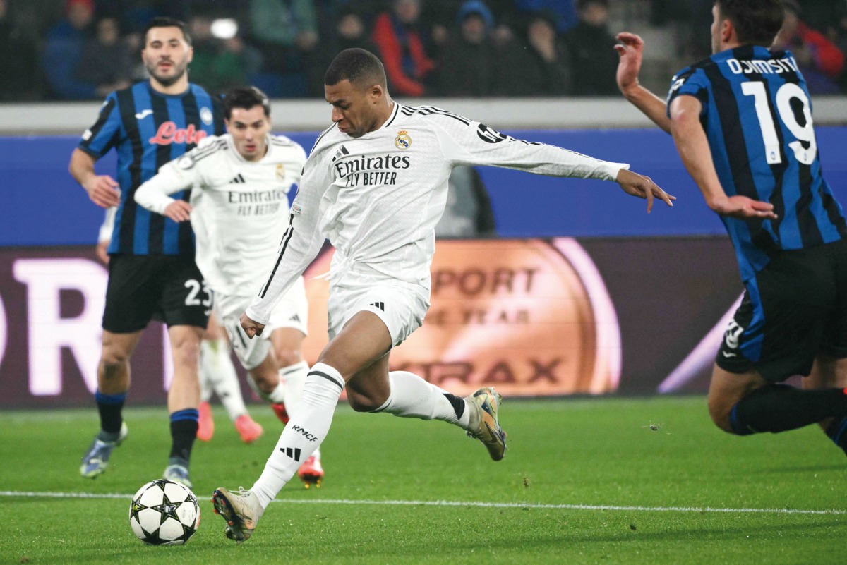 Kylian Mbappe shoots to score Real Madrid’s first goal against Atalanta.