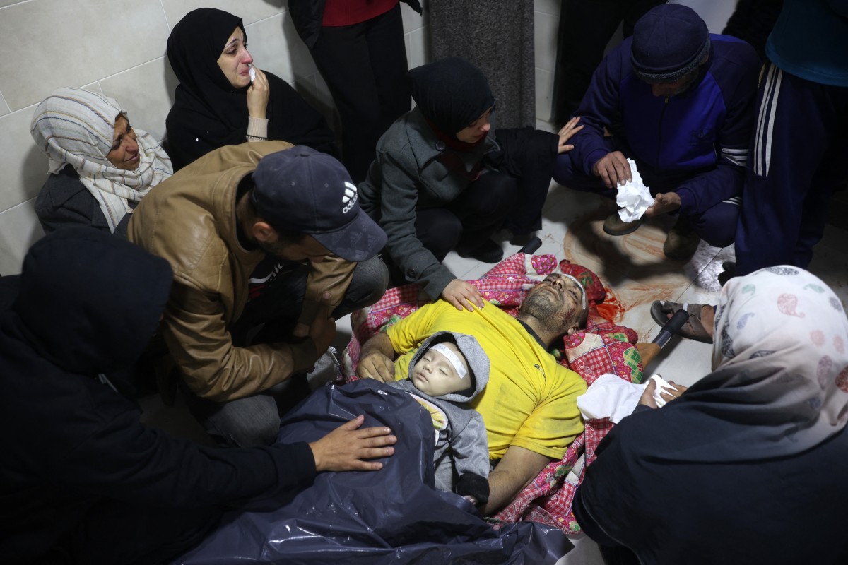 Palestinians mourn relatives, killed in an Israeli airstrike, ahead of their funeral in the Nuseirat refugee in the central Gaza Strip on December 13, 2024. Photo by Eyad BABA / AFP.