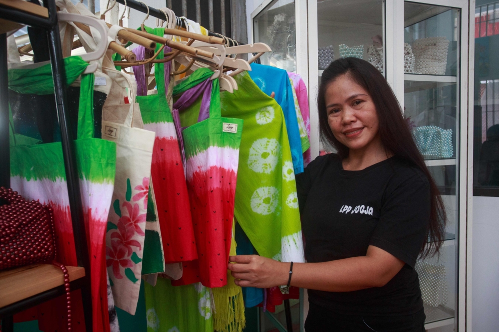 Filipino drug convict on death row in Indonesia, Mary Jane Veloso, shows a batik design she created during her time at Yogyakarta Women's Correctional Institution Class IIB in Wonosari, Yogyakarta on December 13, 2024. (Photo by Devi Rahman / AFP)