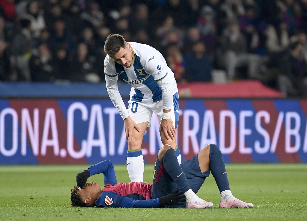 Barcelona's Spanish forward #19 Lamine Yamal reacts on the ground during the Spanish league football match between FC Barcelona and Club Deportivo Leganes SAD at the Estadi Olimpic Lluis Companys in Barcelona on December 15, 2024. (Photo by Josep LAGO / AFP)
