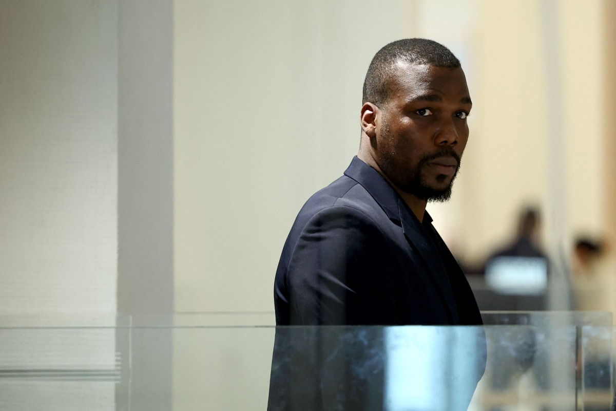 (FILES) Mathias Pogba, who is accused of pressurising his brother French football player Paul Pogba and his family, leaves the Paris Criminal Court after his trial was suspended, in Paris on November 26, 2024. (Photo by Anne-Christine POUJOULAT / AFP)
