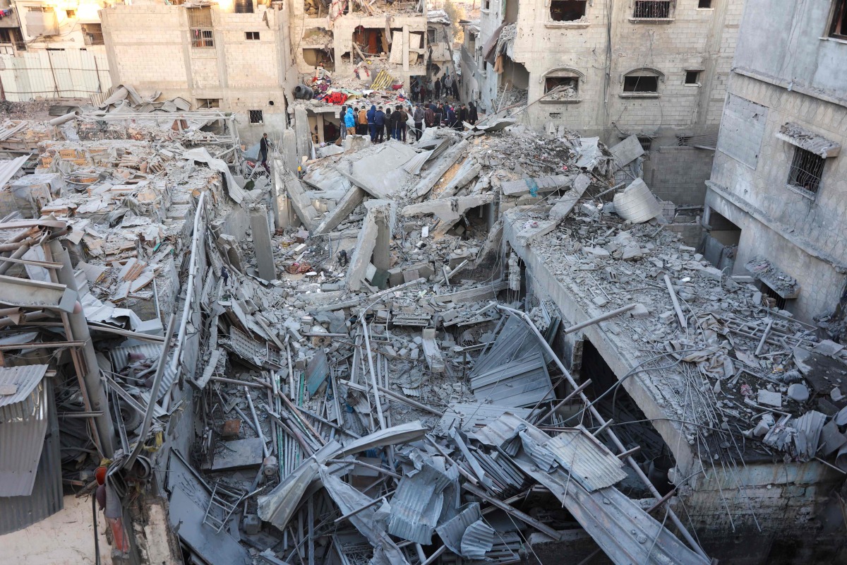 People look for survivors following an Israeli strike on a home belonging to the al-Zaytouniyah family, in the al-Daraj neighbourhood in Gaza City, in the central Gaza Strip on December 19, 2024. Photo by Omar AL-QATTAA / AFP