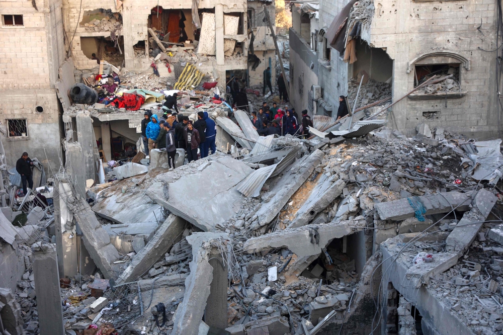 People look for survivors following an Israeli strike on a home belonging to the al-Zaytouniyah family, in the al-Daraj neighbourhood in Gaza City, in the central Gaza Strip on December 19, 2024. (Photo by Omar Al-Qattaa / AFP)