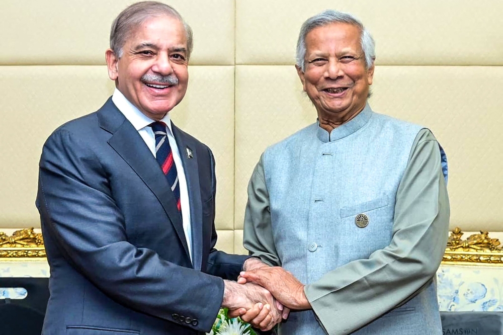 In this handout photo released by Pakistan's Press Information Department (PID), Pakistan's Prime Minister Shehbaz Sharif (left) shakes hands with Bangladesh's interim leader Muhammad Yunus during a bilateral meeting on the sidelines of the D-8 summit in Cairo on December 19, 2024. (Photo by Pakistan's Press Information Department (PID) / AFP) 