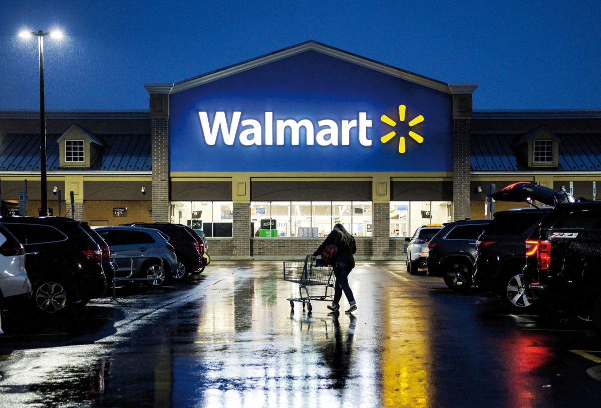 File photo of a shopper pushing a cart through the parking lot of a Walmart on the morning of Black Friday in Wilmington, Delaware. (AFP)